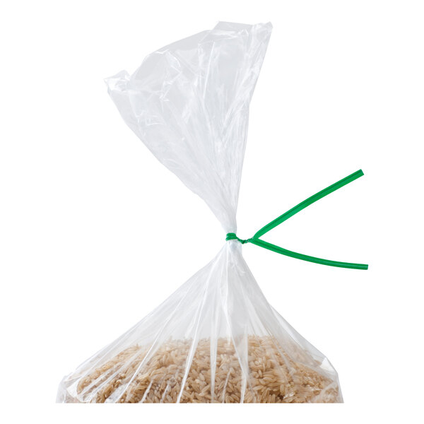 A clear plastic bag filled with rice is sealed with a green twist tie.