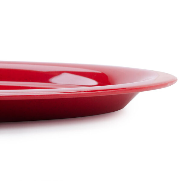 A close-up of a red oval platter with white accents.