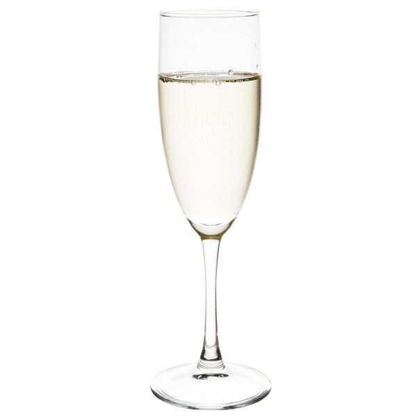 An Arcoroc champagne flute filled with liquid.