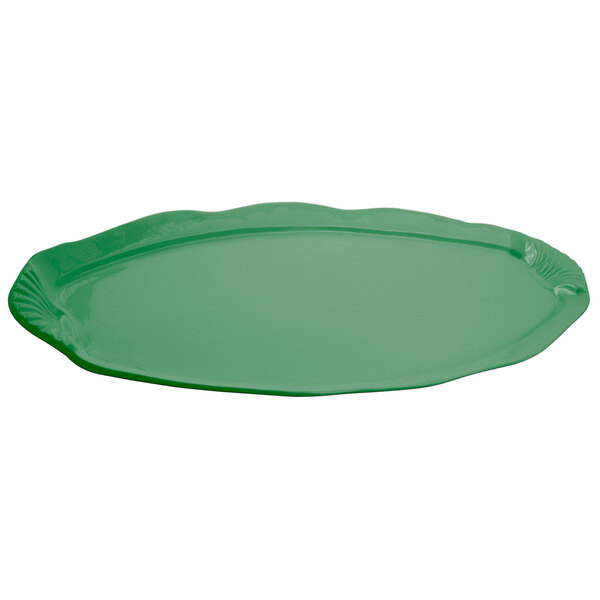 A green cast aluminum shell and fish platter with a scalloped edge.