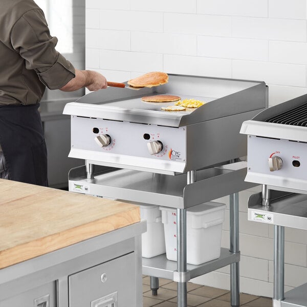 A man cooking on a Cooking Performance Group gas countertop griddle.