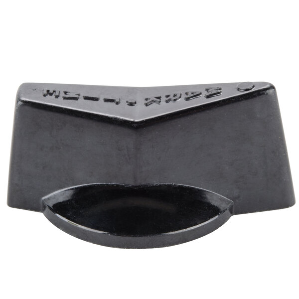 A black plastic block with a black circle on it.
