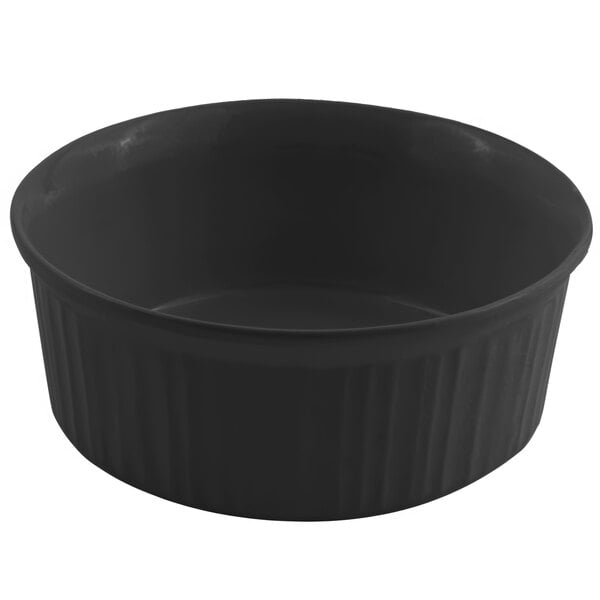 A black Bon Chef cast aluminum casserole dish with a lid on a white surface.