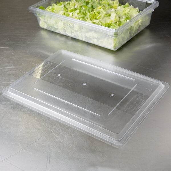 A clear Rubbermaid food storage box lid on a plastic container of lettuce.