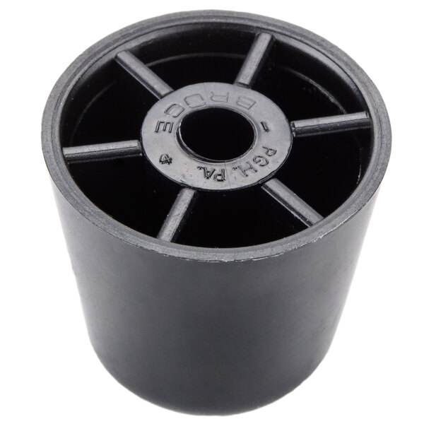 A black plastic cylinder with a round metal center and holes.
