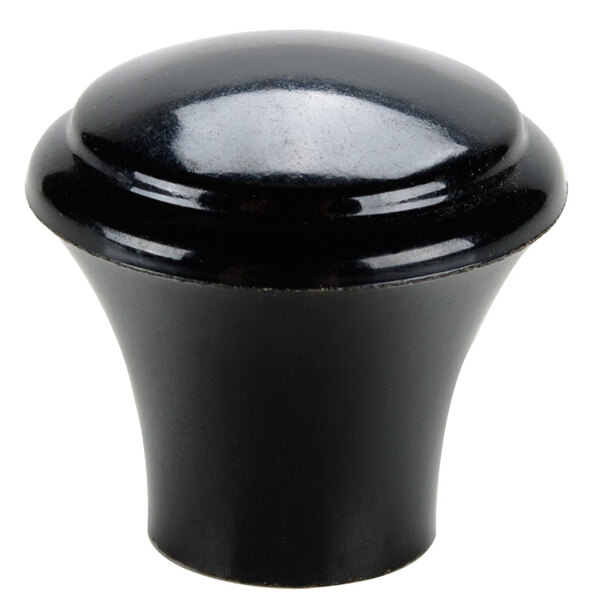 A close-up of a black round plastic knob.