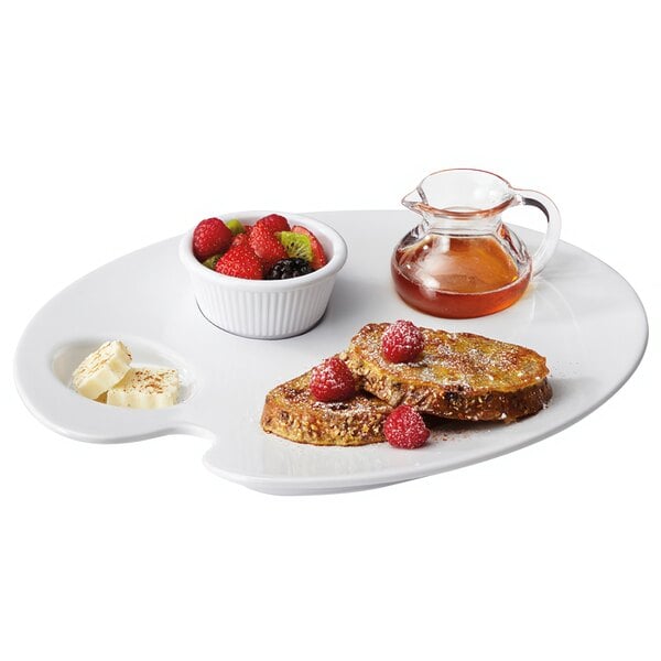 A white GET Let's Party painter's plate with a bowl of fruit and a slice of toast.