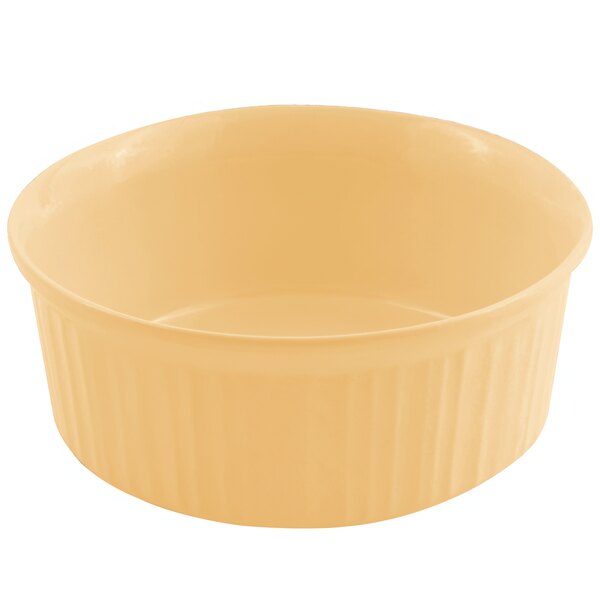 A Bon Chef ginger sandstone casserole dish with a yellow rim.