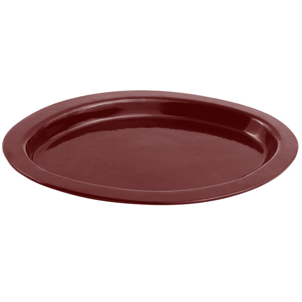 A Bon Chef terra cotta cast aluminum oval casserole dish with a sandstone finish.