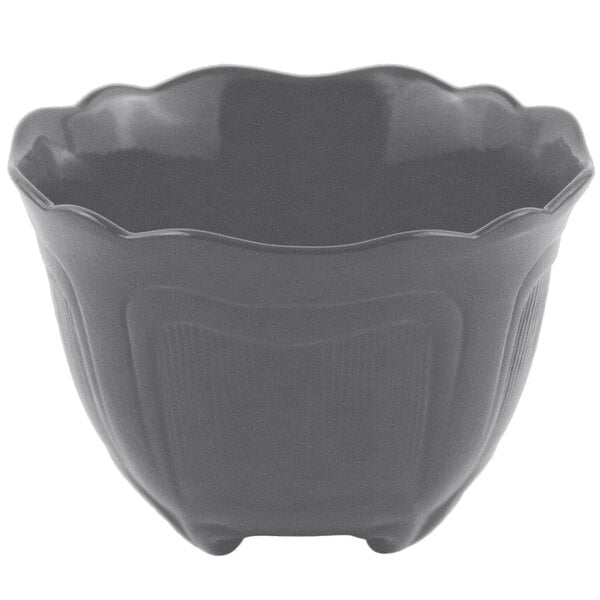 A smoke gray Bon Chef cast aluminum garnish bowl with a curved edge.