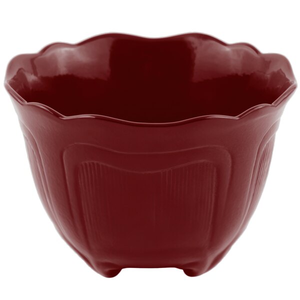 A red Bon Chef cast aluminum garnish bowl with a scalloped edge.