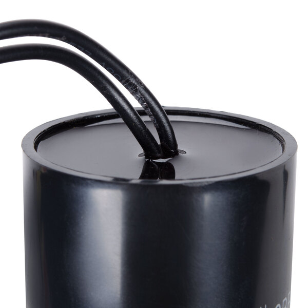 A black round Avantco capacitor with wires.