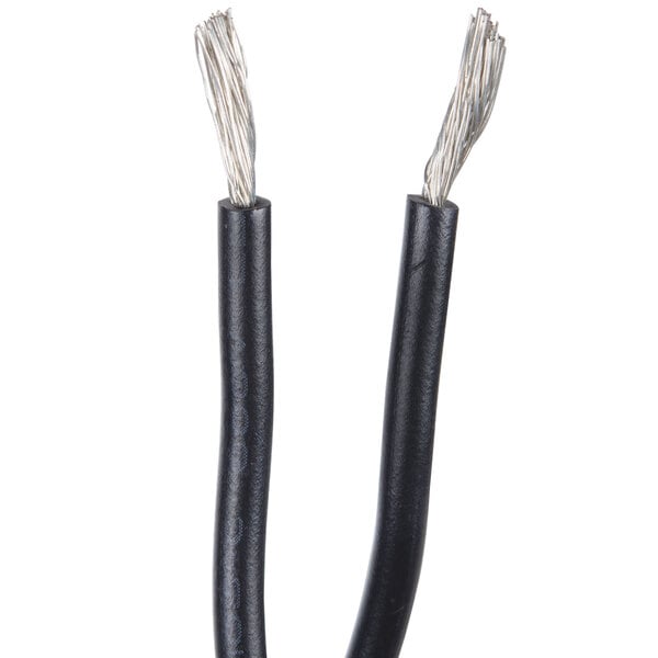 A close up of a black object with two black wires and white wires.