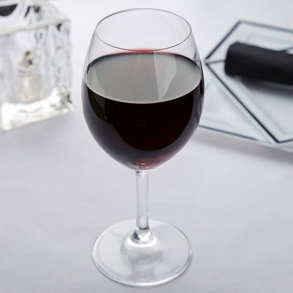Standard red wine glass filled with red wine on a table