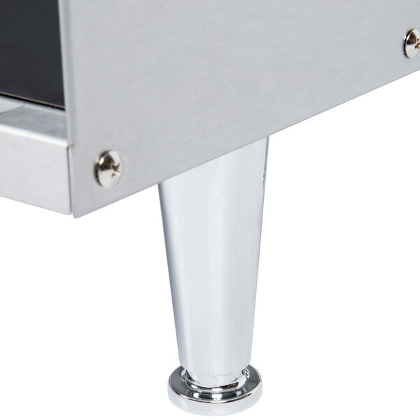 An APW Wyott vertical conveyor bun grill toaster on a stainless steel table with a metal base.