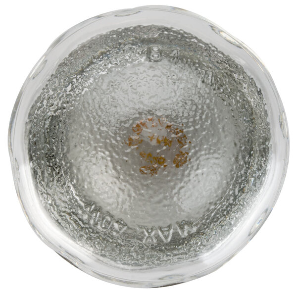 A clear glass bowl with a yellow mark inside.