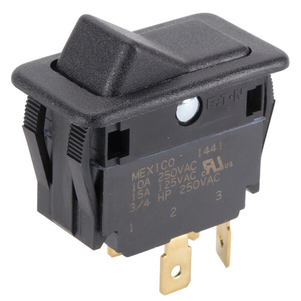 A black electrical switch with a square button and a yellow light.