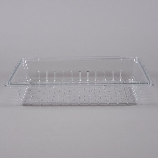 A clear plastic container with small holes on the bottom.