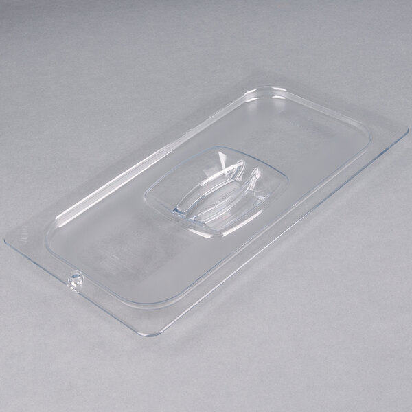 A clear plastic Rubbermaid food pan lid with a handle and peg hole.
