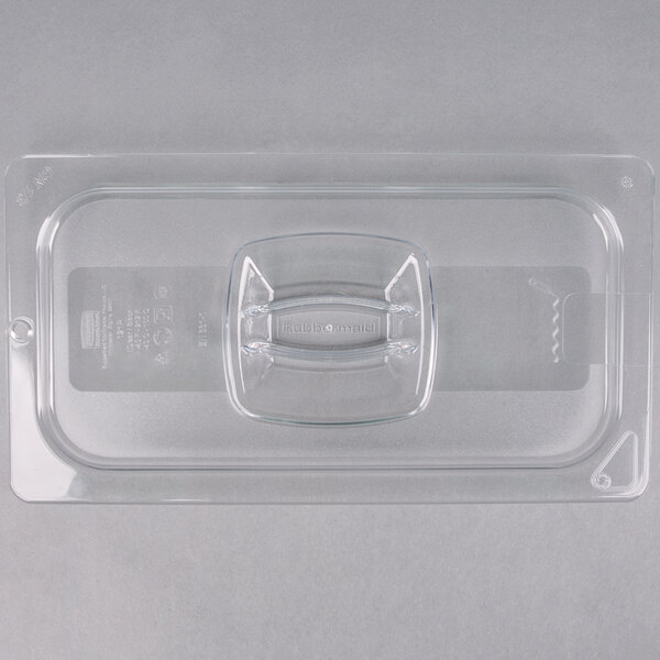 A clear plastic Rubbermaid food pan lid with a handle and peg hole.