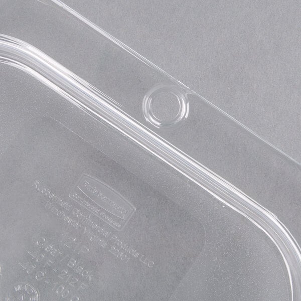A clear Rubbermaid plastic food pan lid with a handle and hole.