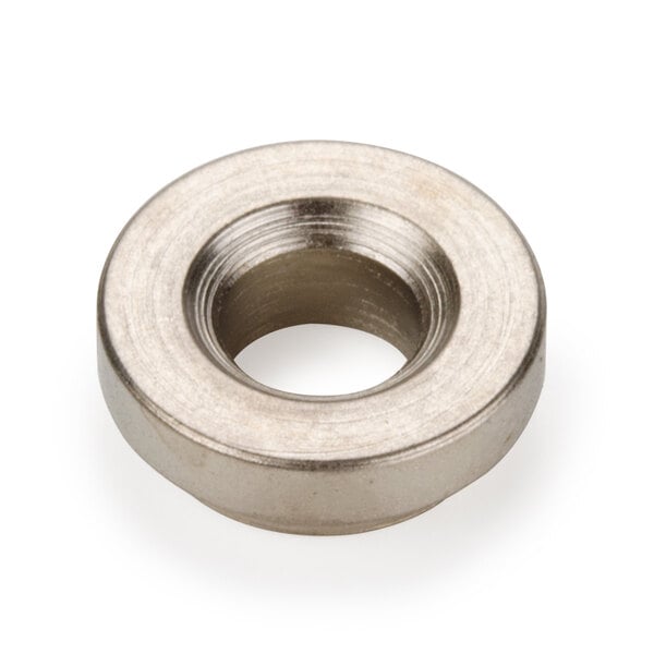 A close-up of a round metal nut.