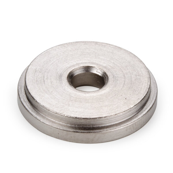A silver round metal nut with a hole in the center.