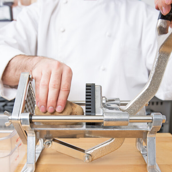 A chef using a Nemco Guide Rod to peel potatoes.