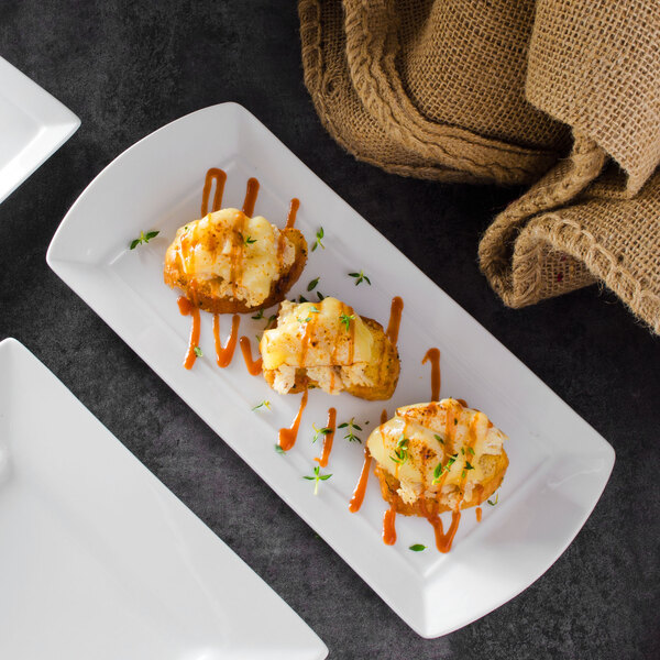 A rectangular white porcelain platter with food on it.