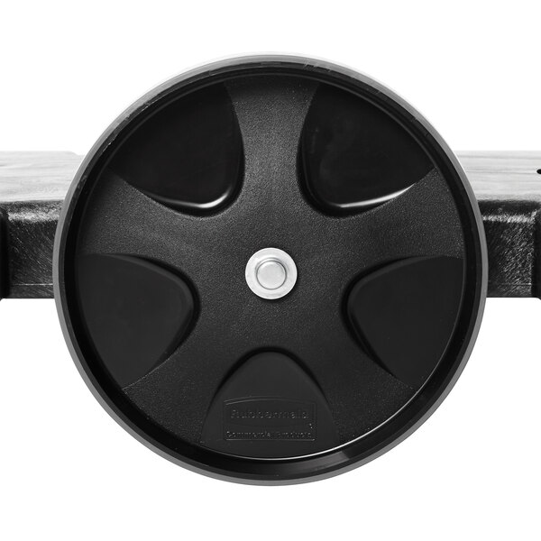 A black Rubbermaid tandem dolly wheel with a round center.