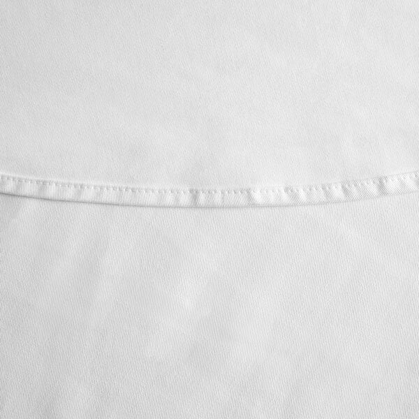 A close up of a white hemmed poly cotton tablecloth with a small white line.