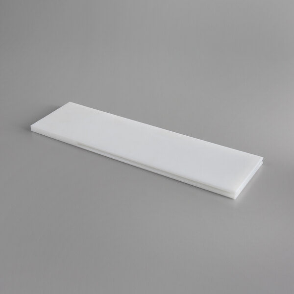 A white rectangular plastic slide board.