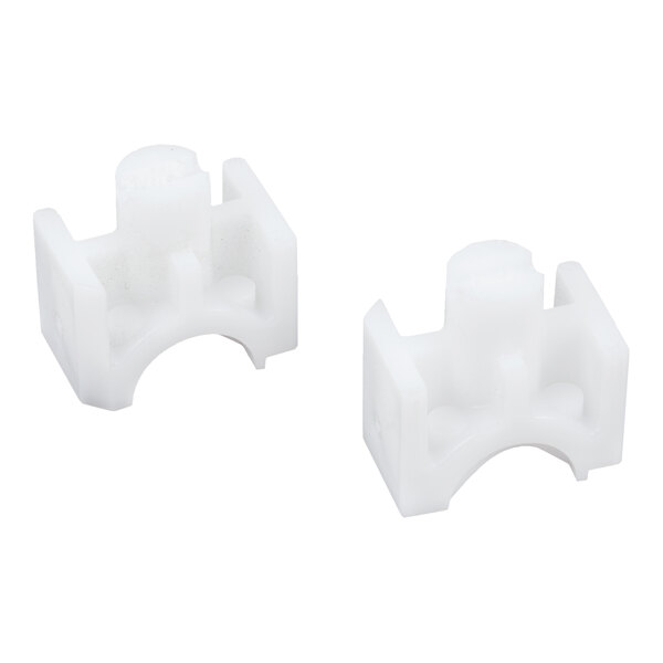 Two small, white, plastic components with a block-like shape and curved cutouts.