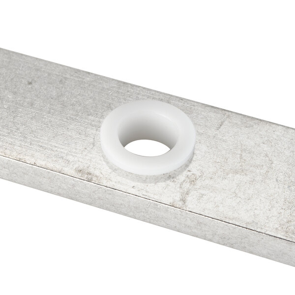 A metal Nemco Cross Bar with a white plastic ring and a white circle with a hole.