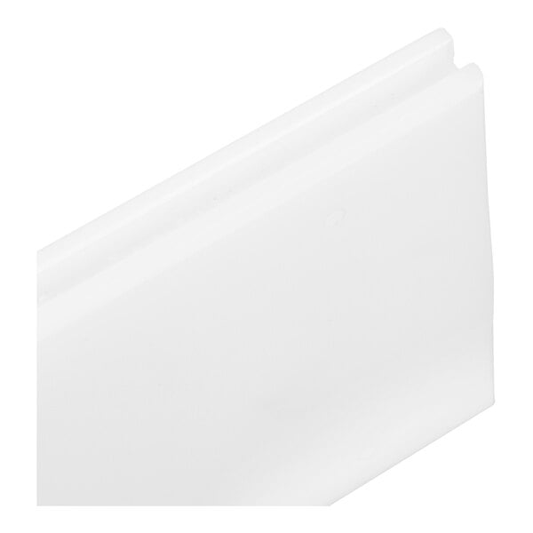 A close-up view of a white, rectangular plastic component with a grooved edge.