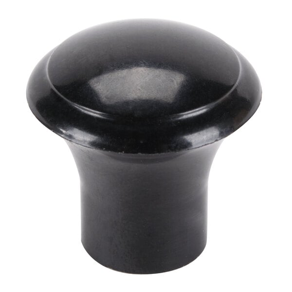 A close-up of a black round knob.