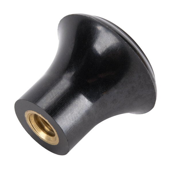 A close-up of a black plastic knob with a gold center.