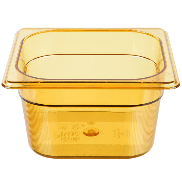 A Rubbermaid amber plastic food pan with a lid on a counter.
