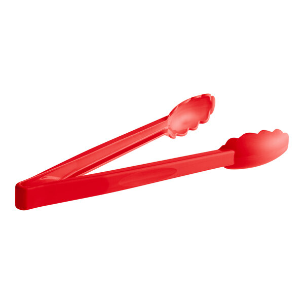 A pair of red plastic tongs with scalloped edges.