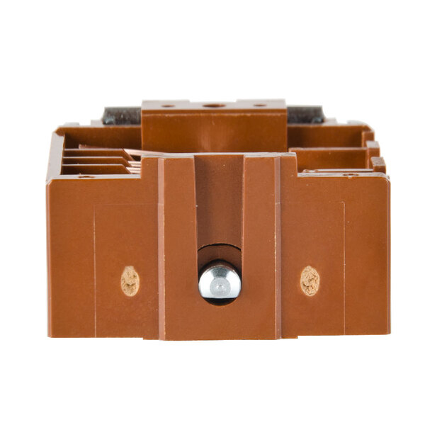 A brown plastic Nemco switch box with two holes and a metal bolt.