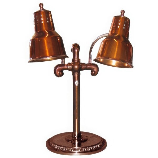 A copper lamp with two heat bulbs on a round base.