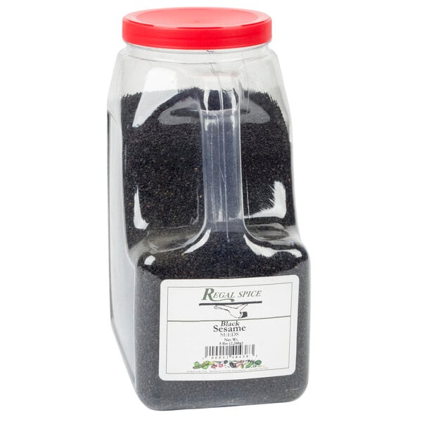 A plastic container of Regal black sesame seeds with a clear handle.