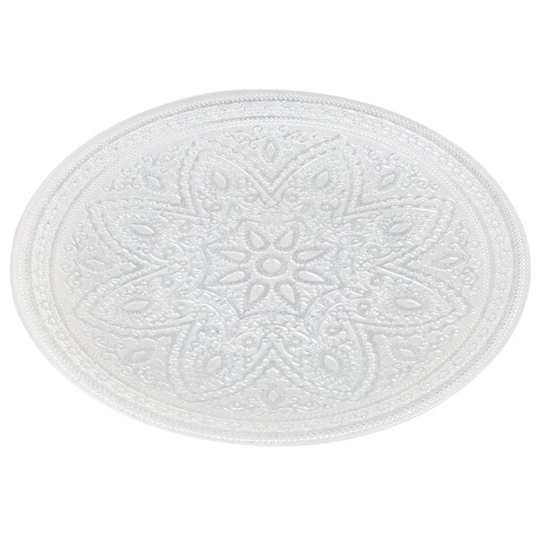 A white Charge It by Jay glass charger plate with a circular pattern on the rim.