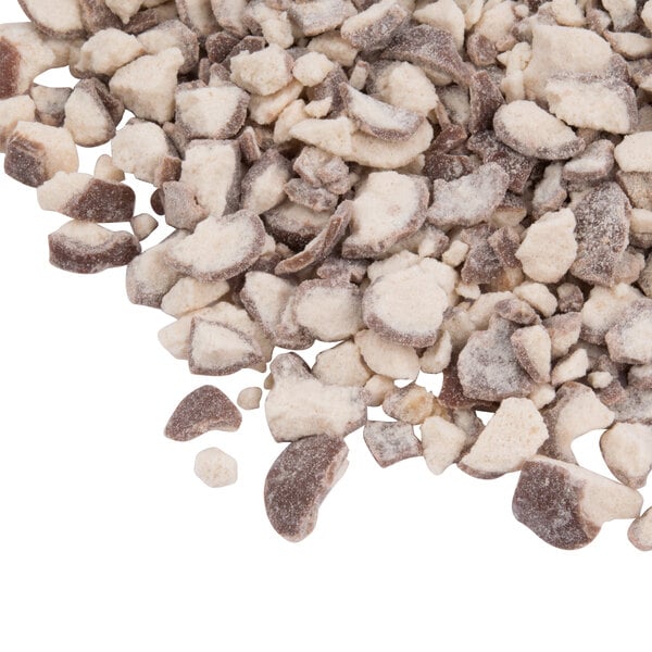 A pile of white and brown pieces of Chopped Whoppers Malt Balls.