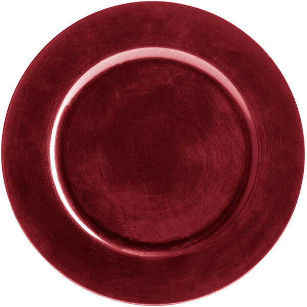 A red Charge It by Jay plastic charger plate on a table.