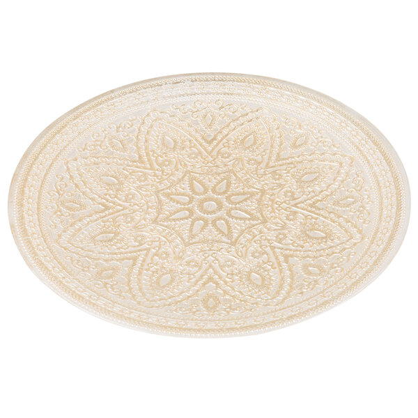 A white Charge It by Jay glass charger plate with a gold patterned border.