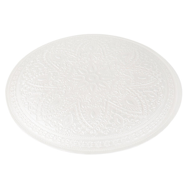 A white glass charger plate with a circular gold pattern on it.