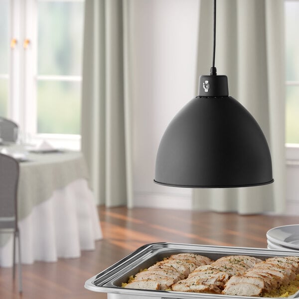 A Hanson Heat Lamps ceiling mount heat lamp with a black finish over a tray of meat on a table.