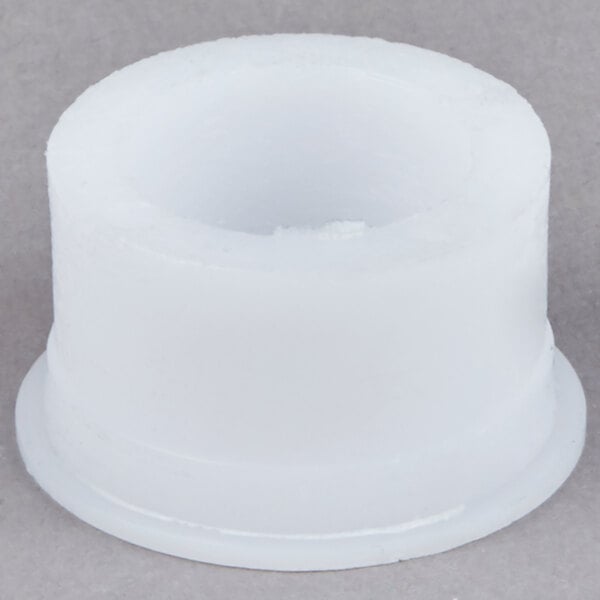 A white plastic Bar Maid bearing shaft with a hole in it.