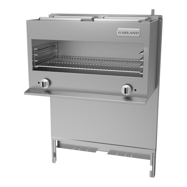 A stainless steel Garland cheese melter with a rack on top.